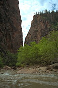 The water flows through a narrow gap between cliffs